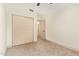 Bedroom features neutral walls and carpet, large closet, and access to additional rooms at 2027 S Rowen St, Mesa, AZ 85209