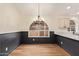 Dining room featuring wainscoting, chandelier, wood floors, and ample natural light at 2027 S Rowen St, Mesa, AZ 85209
