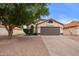 Charming single-story home featuring a well-manicured front yard and a neutral paint scheme at 2027 S Rowen St, Mesa, AZ 85209