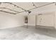 Spacious garage with epoxy flooring, water heater, and modern garage door at 2027 S Rowen St, Mesa, AZ 85209