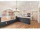 Bright kitchen features stainless appliances, light cabinets, and a marble counter-topped peninsula with views of the outdoor at 2027 S Rowen St, Mesa, AZ 85209
