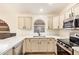 Updated kitchen features quartz countertops, stainless appliances, and light cabinets at 2027 S Rowen St, Mesa, AZ 85209
