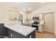 This updated kitchen features stainless appliances, and quartz countertops with a black faucet at 2027 S Rowen St, Mesa, AZ 85209