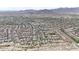 Expansive aerial view of a residential neighborhood nestled against scenic mountains at 20421 W Legend Trl, Buckeye, AZ 85396