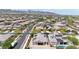 Panoramic aerial shot of homes in a Primary-planned community, showcasing solar panels, landscaping, and desert vistas at 20421 W Legend Trl, Buckeye, AZ 85396