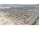 Drone shot of a Primary-planned community highlighting its homes, streets, landscaping, and surrounding desert terrain at 20421 W Legend Trl, Buckeye, AZ 85396