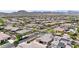 Aerial view of a neighborhood featuring well-maintained homes, solar panels, and lush green landscaping at 20421 W Legend Trl, Buckeye, AZ 85396