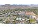 This aerial view features the apartment complex, a community pool, and scenic mountain views at 20421 W Legend Trl, Buckeye, AZ 85396