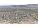 Expansive aerial view of a well-planned community nestled against a scenic mountain backdrop in a desert environment at 20421 W Legend Trl, Buckeye, AZ 85396