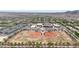 Expansive aerial view of the community featuring a school, baseball field, and neatly planned residential streets at 20421 W Legend Trl, Buckeye, AZ 85396
