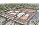 This aerial view features the school buildings with sports fields and ample parking at 20421 W Legend Trl, Buckeye, AZ 85396