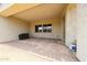 Covered back patio with brick flooring and neutral-colored stucco walls at 20421 W Legend Trl, Buckeye, AZ 85396