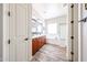 Bathroom featuring a double vanity, separate tub, and wood-style flooring at 20421 W Legend Trl, Buckeye, AZ 85396
