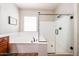 Clean and modern bathroom with a separate shower and soaking tub at 20421 W Legend Trl, Buckeye, AZ 85396