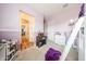 Bedroom with lofted bed, wood floors, and purple accent pieces at 20421 W Legend Trl, Buckeye, AZ 85396