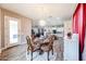 Dining space with chandelier, and direct sightlines to kitchen and living areas at 20421 W Legend Trl, Buckeye, AZ 85396