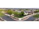 Inviting corner lot home featuring manicured landscaping, charming trees, and a well-maintained exterior at 20421 W Legend Trl, Buckeye, AZ 85396