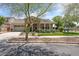 Charming home with stone accents, a two-car garage, a covered porch, and a well-maintained front yard at 20421 W Legend Trl, Buckeye, AZ 85396