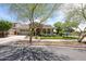 Charming single-Gathering home with a stone facade, well-manicured lawn, inviting front porch and a three car garage at 20421 W Legend Trl, Buckeye, AZ 85396