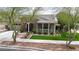 Charming single-story home with a stone facade, inviting porch, lush landscaping, and a well-manicured lawn at 20421 W Legend Trl, Buckeye, AZ 85396