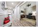 Hallway featuring wood-look tile flooring and views into the living room and an office space at 20421 W Legend Trl, Buckeye, AZ 85396