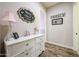 Hallway featuring wood floors, a white dresser with decor and wall art at 20421 W Legend Trl, Buckeye, AZ 85396