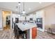 Modern kitchen featuring an island with seating, granite countertops, and stainless steel appliances at 20421 W Legend Trl, Buckeye, AZ 85396