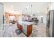 Open concept kitchen with central island and view into adjacent living and dining areas at 20421 W Legend Trl, Buckeye, AZ 85396