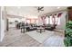 Spacious living room with tile flooring, leather sofas, area rug, and views of the connected kitchen at 20421 W Legend Trl, Buckeye, AZ 85396