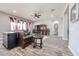 Comfortable living room featuring wood-look tile flooring, large entertainment center, and elegant furnishings at 20421 W Legend Trl, Buckeye, AZ 85396