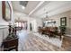 Open floor plan showcasing the living room, dining room, and kitchen with wood-look tile floors at 20421 W Legend Trl, Buckeye, AZ 85396