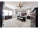 Spacious main bedroom with two windows, carpet flooring, and dark-wood dressers at 20421 W Legend Trl, Buckeye, AZ 85396