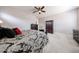 Spacious main bedroom with ceiling fan, carpet flooring, and matching dark-wood dressers at 20421 W Legend Trl, Buckeye, AZ 85396