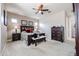 Bright main bedroom with carpet flooring, ceiling fan, and two windows at 20421 W Legend Trl, Buckeye, AZ 85396