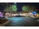 A street view illuminated with holiday decorations and lights displays on each home at 20421 W Legend Trl, Buckeye, AZ 85396