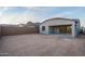 Backyard view showing a covered patio, stucco exterior, and privacy wall at 20961 W Pasadena Ave, Buckeye, AZ 85396