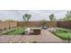 This lovely backyard area comes with a putting green and a fire pit at 20961 W Pasadena Ave, Buckeye, AZ 85396