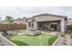 Entertainer's backyard with mini golf, fire pit, mountain views, and covered patio at 20961 W Pasadena Ave, Buckeye, AZ 85396