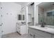 Modern bathroom with dual vanities, granite countertops, and a walk-in closet at 20961 W Pasadena Ave, Buckeye, AZ 85396