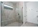 Contemporary bathroom showcasing a glass-enclosed shower with a built-in bench at 20961 W Pasadena Ave, Buckeye, AZ 85396