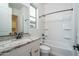 Bright bathroom featuring a granite countertop vanity and a combined tub and shower at 20961 W Pasadena Ave, Buckeye, AZ 85396