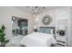This well-lit bedroom has unique architectural design with gray walls and decor at 20961 W Pasadena Ave, Buckeye, AZ 85396