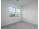 Sunlit bedroom with plush carpeting and ample natural light streaming through large windows at 20961 W Pasadena Ave, Buckeye, AZ 85396