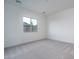 Bright, carpeted bedroom features a window with views of the surrounding landscape at 20961 W Pasadena Ave, Buckeye, AZ 85396