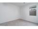 Simple bedroom featuring a window with view and tiled floors at 20961 W Pasadena Ave, Buckeye, AZ 85396