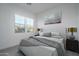 Well-appointed bedroom with a comfortable bed, stylish lamps, and exterior view at 20961 W Pasadena Ave, Buckeye, AZ 85396