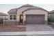 Charming single-Gathering home featuring a gray garage door and brick-paved driveway at 20961 W Pasadena Ave, Buckeye, AZ 85396