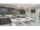 Stylish kitchen features sleek cabinetry, stainless steel appliances, and marble countertops at 20961 W Pasadena Ave, Buckeye, AZ 85396