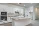 Modern kitchen with white cabinetry, stainless steel appliances, and a large island at 20961 W Pasadena Ave, Buckeye, AZ 85396