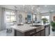 Bright kitchen boasts a large island with stainless steel sink and modern lighting at 20961 W Pasadena Ave, Buckeye, AZ 85396